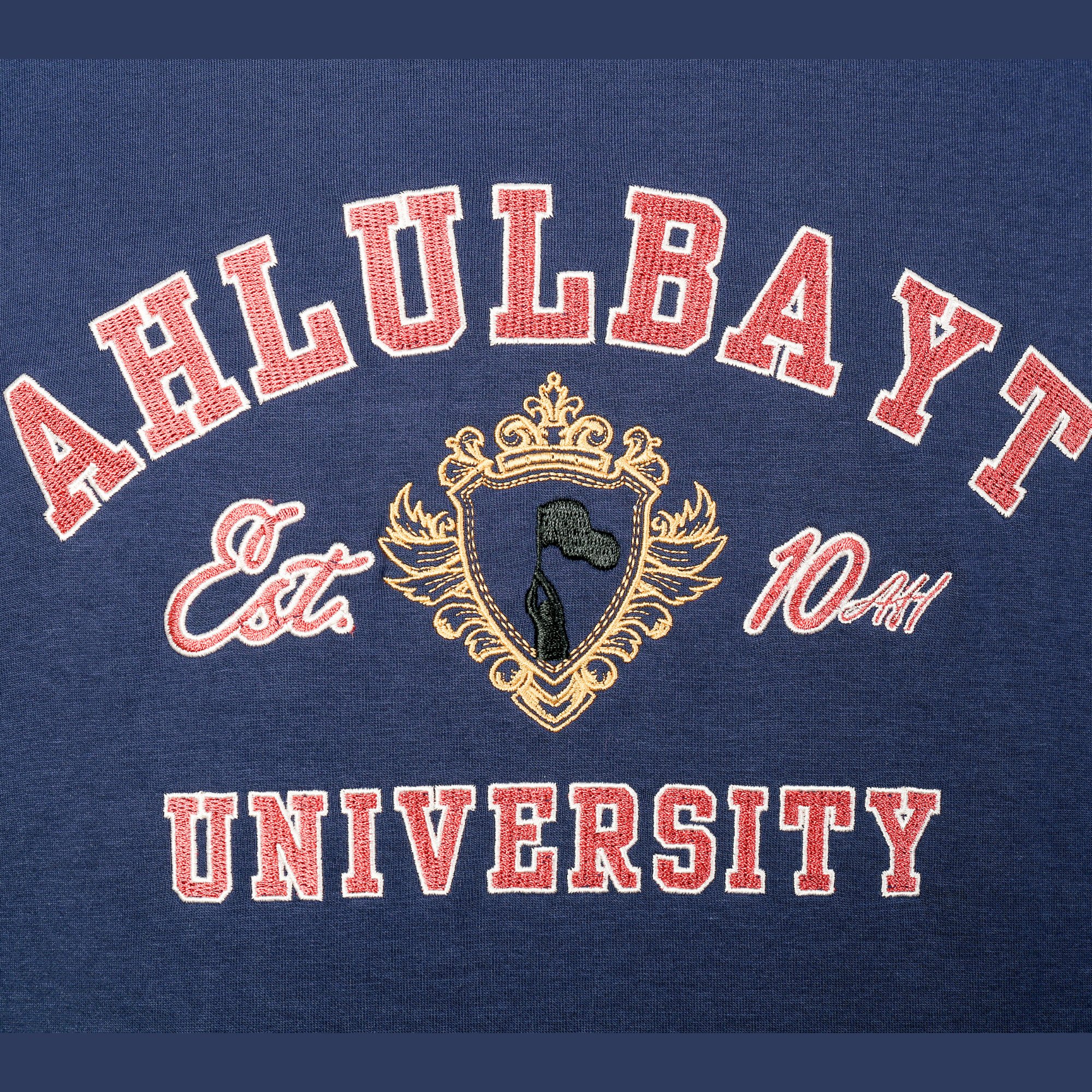 Ahlulbayt University Hoodie - Navy Close-up Close-up of Ahlulbayt University Hoodie varsity artwork detail in navy
